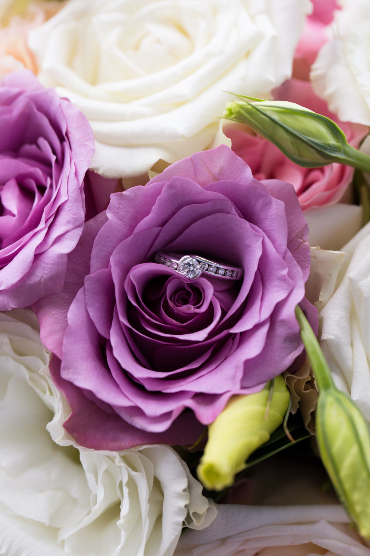 wedding details purple flowers with engagement ring inside