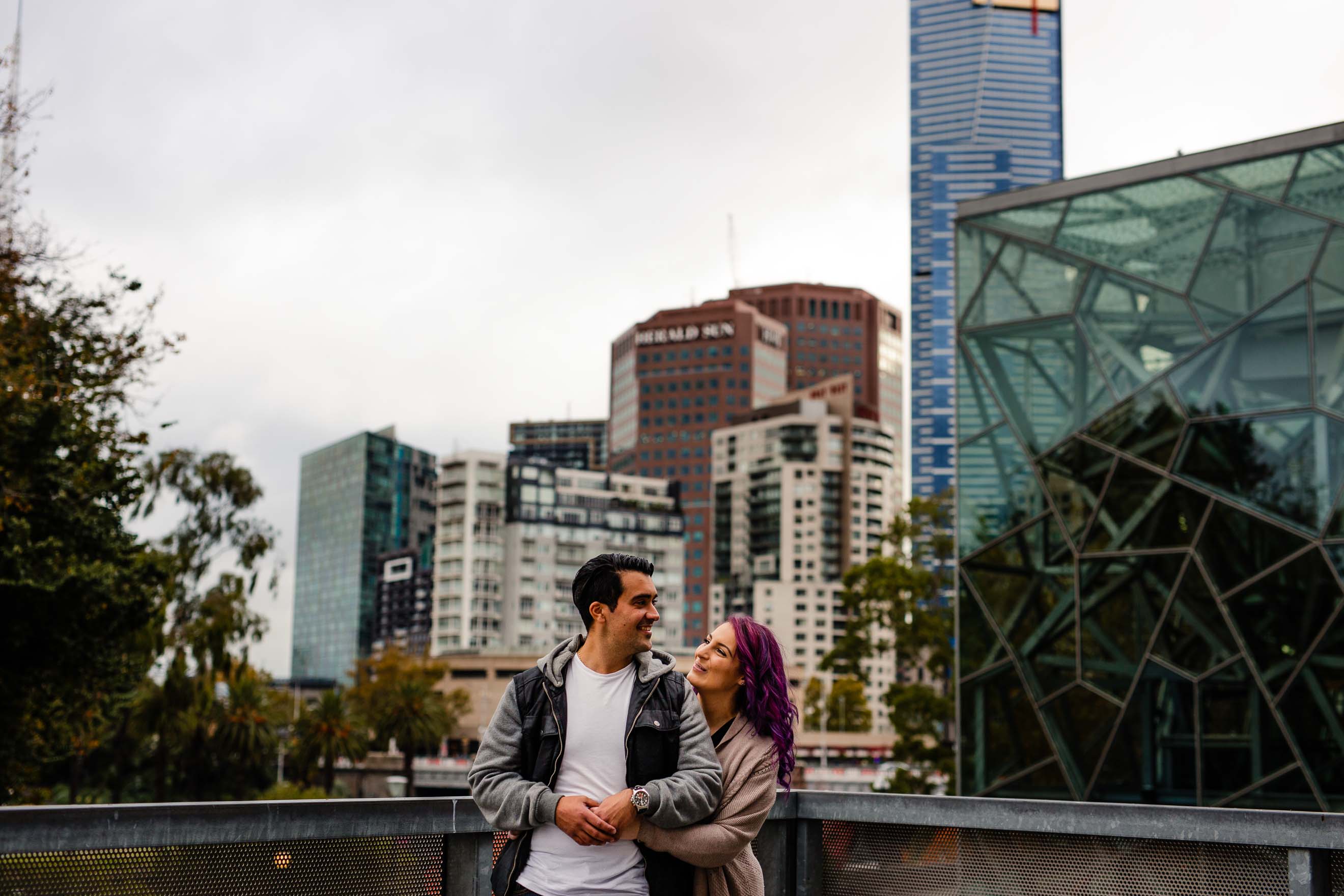 recently engaged couple hugging during an urban engagement shoot near fed square melbourne