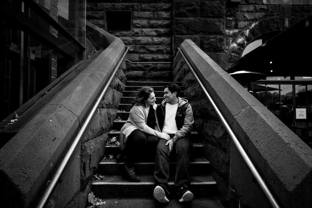 couple snuggling on a old melbourne staircase in south yarra during an urban engagement photo session