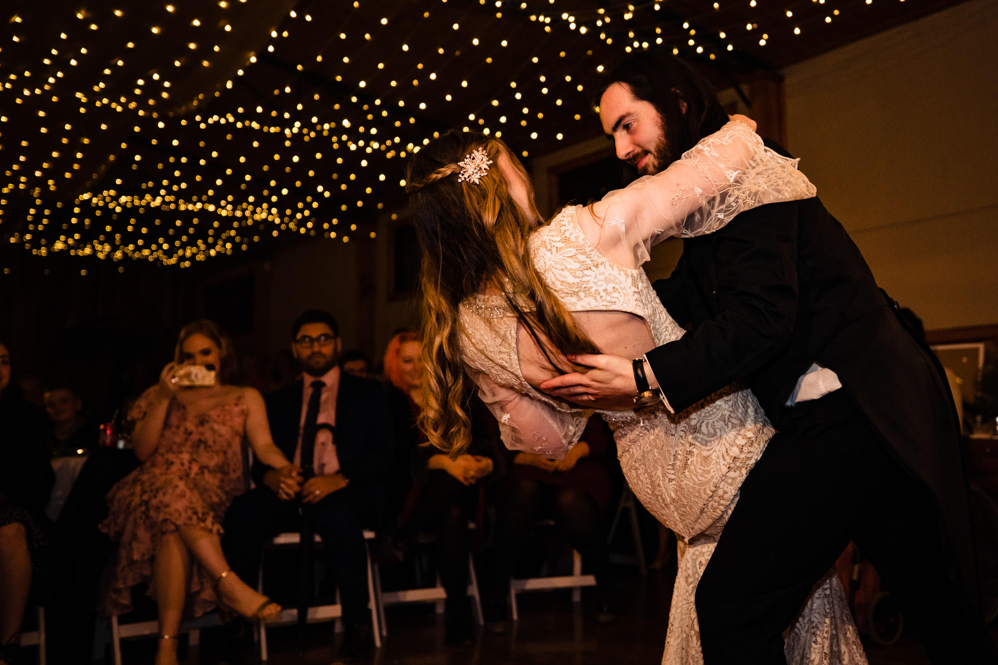 couples first dance moves in the barn at wedding in log cabin ranch