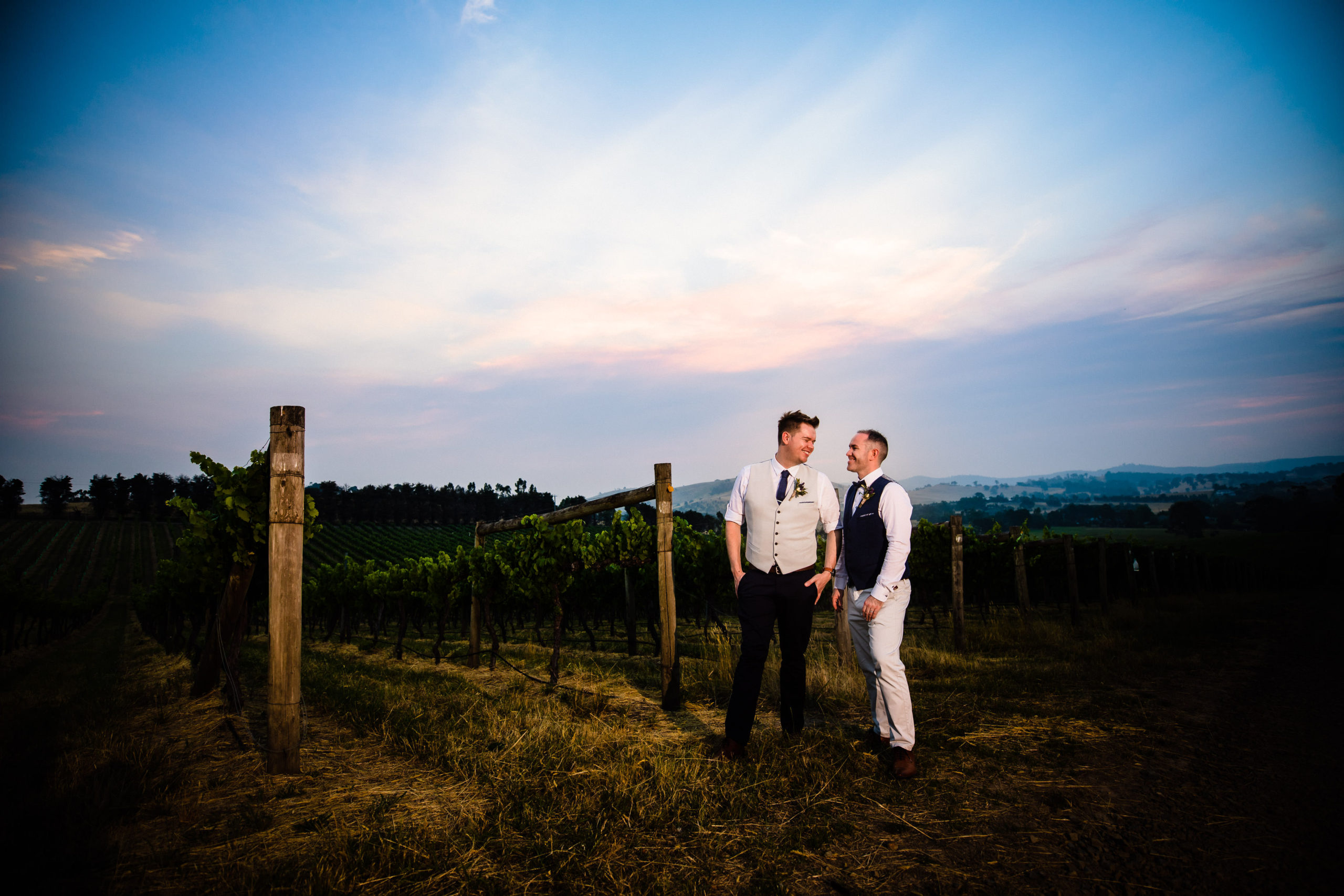 two grooms having their photo taking during sunset