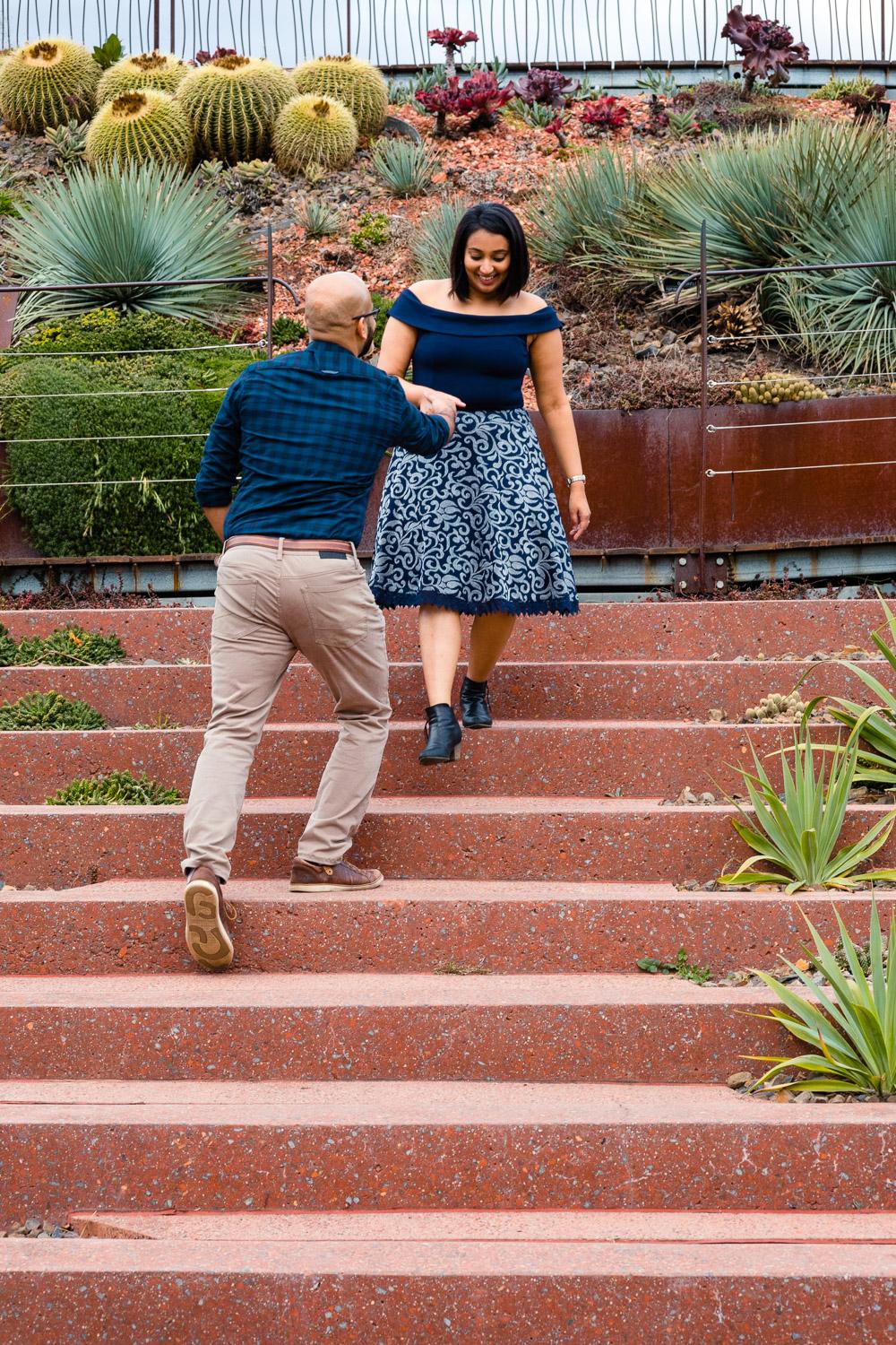 couple holding hand while walking down stairs in melbourne photo shoot