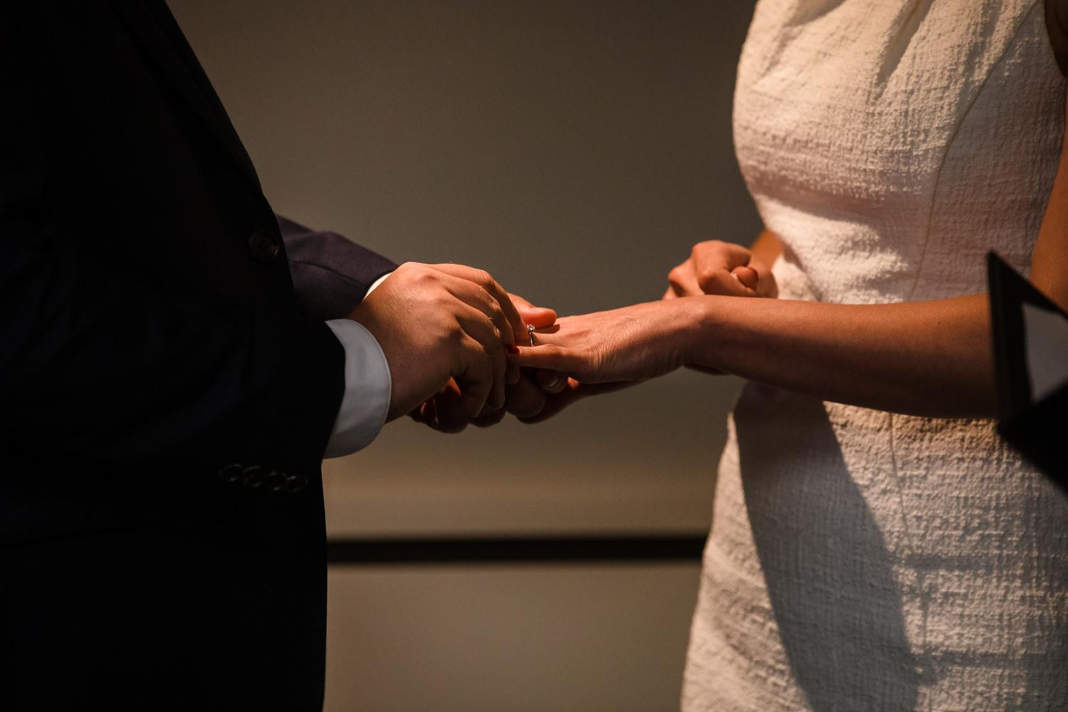 close up photo of hands and rings during elopement