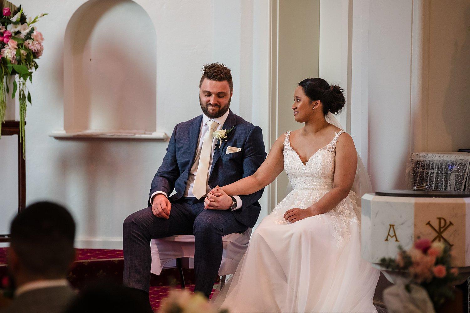 bride and groom share a private moment during their church ceremony