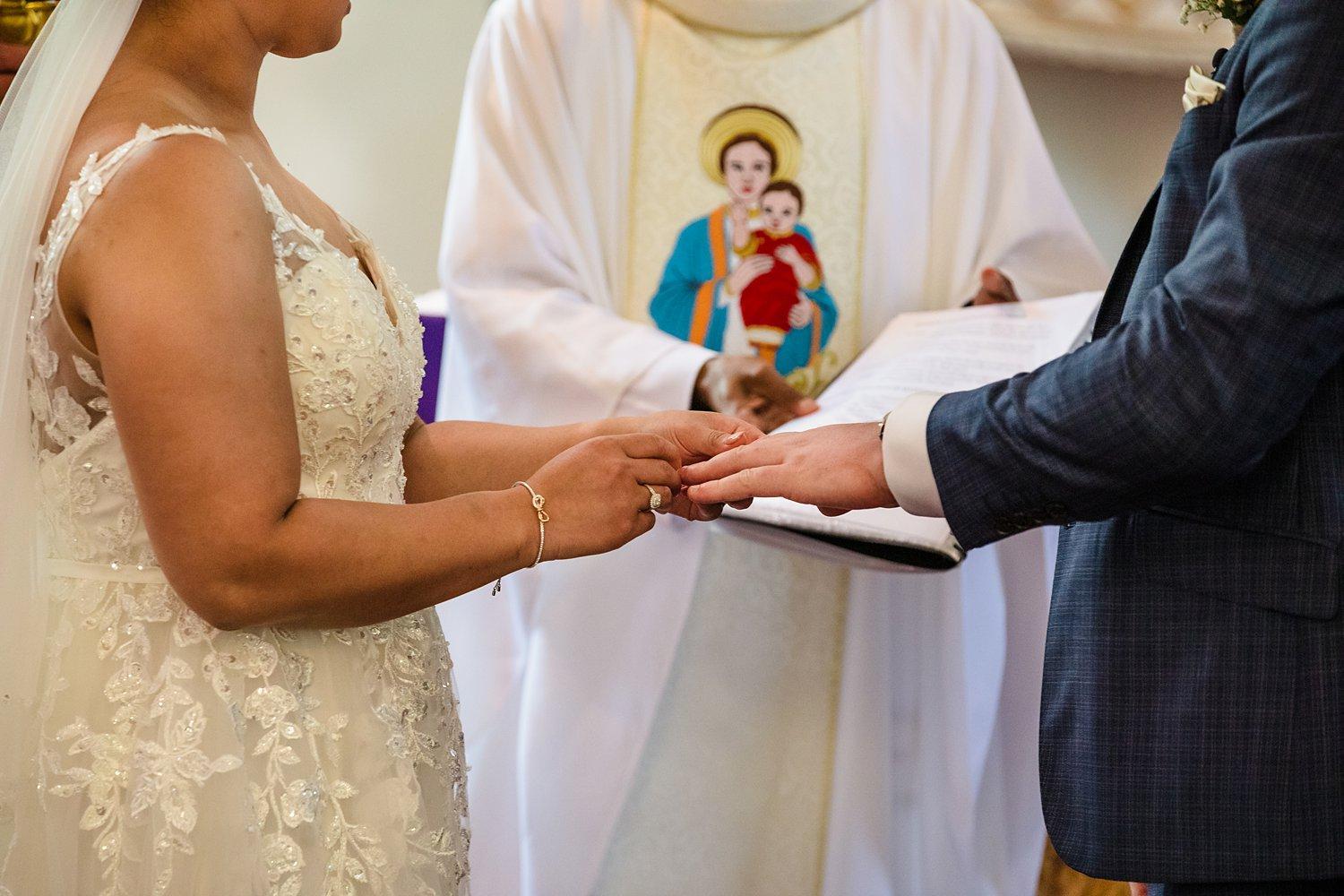 couple exchanging rings during church ceremony