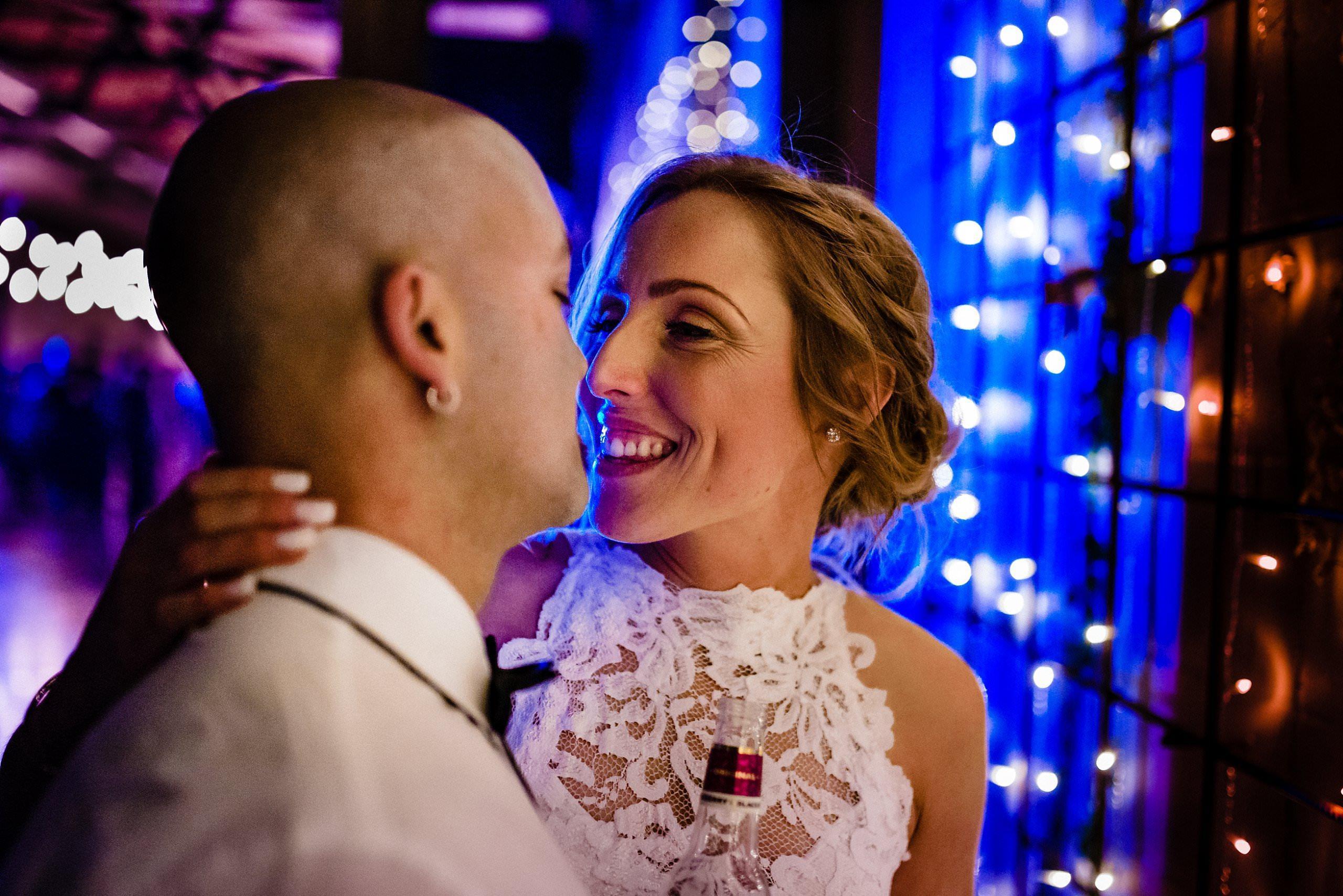 bride and groom just before they kiss in front of the fairy lights at two ton max wedding