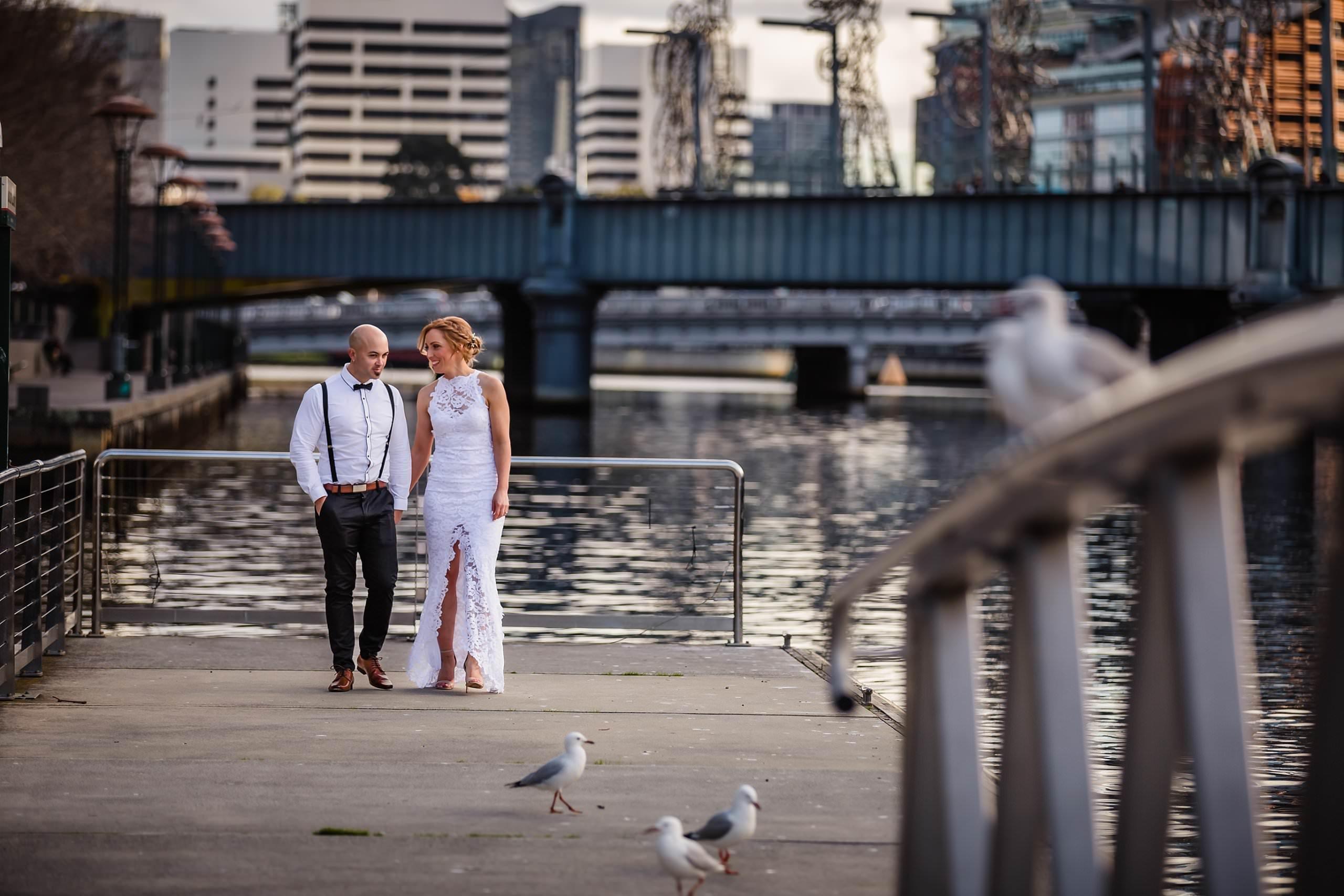 bride and groom walking along the yarra before their two ton max wedding 