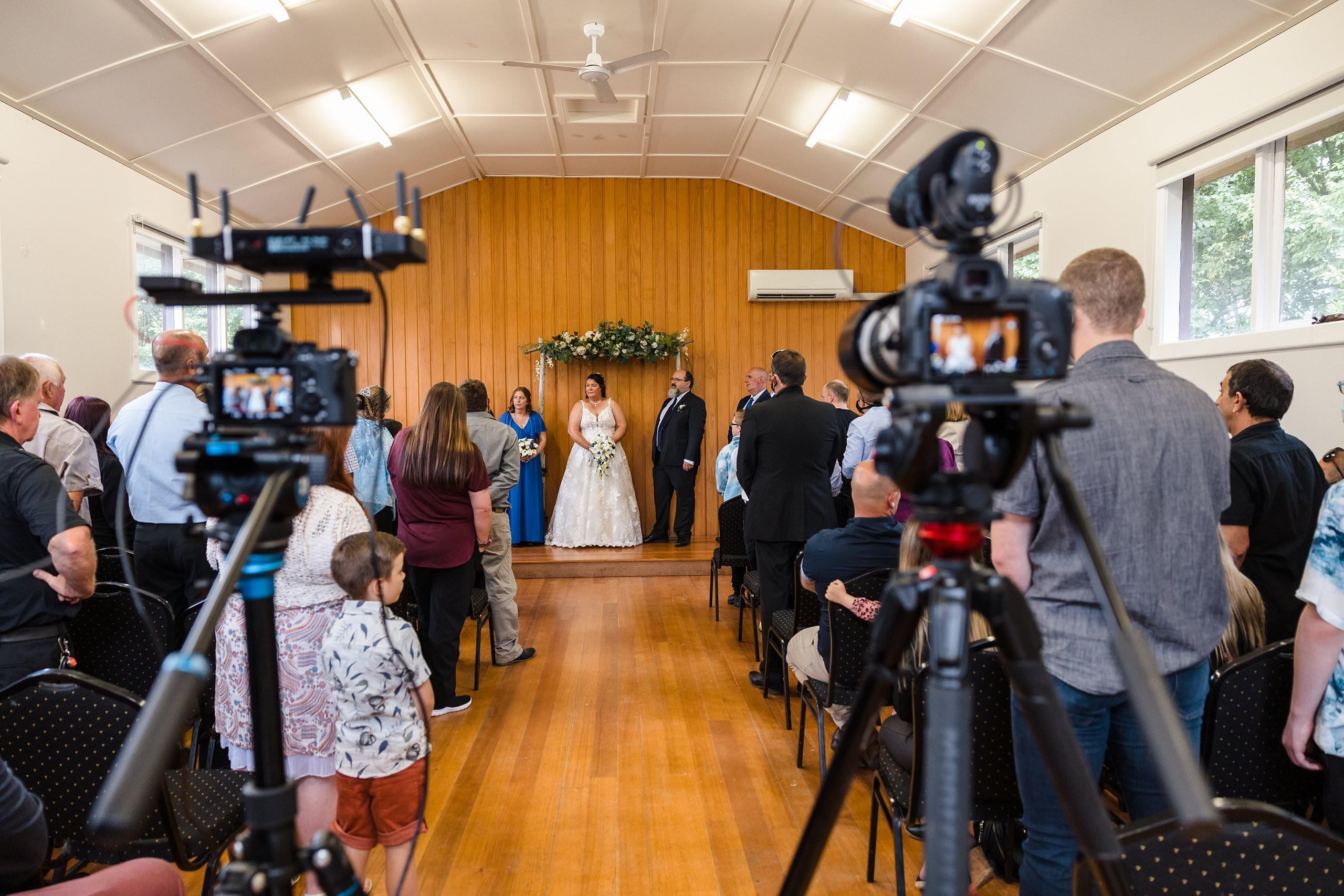 the bride and groom had their wedding ceremony live streamed by bottlebrush films