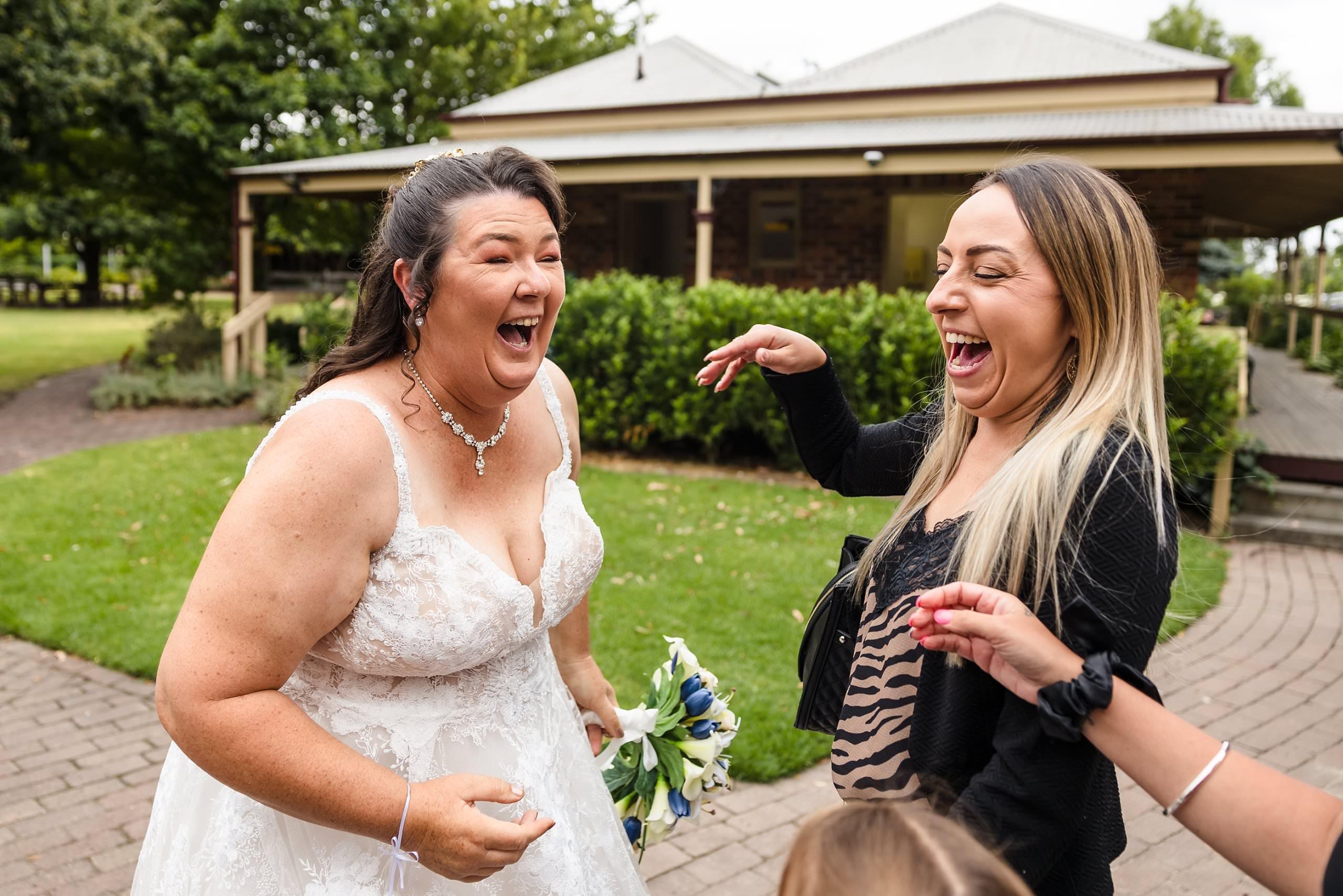 bride laughing with her guests after ceremony