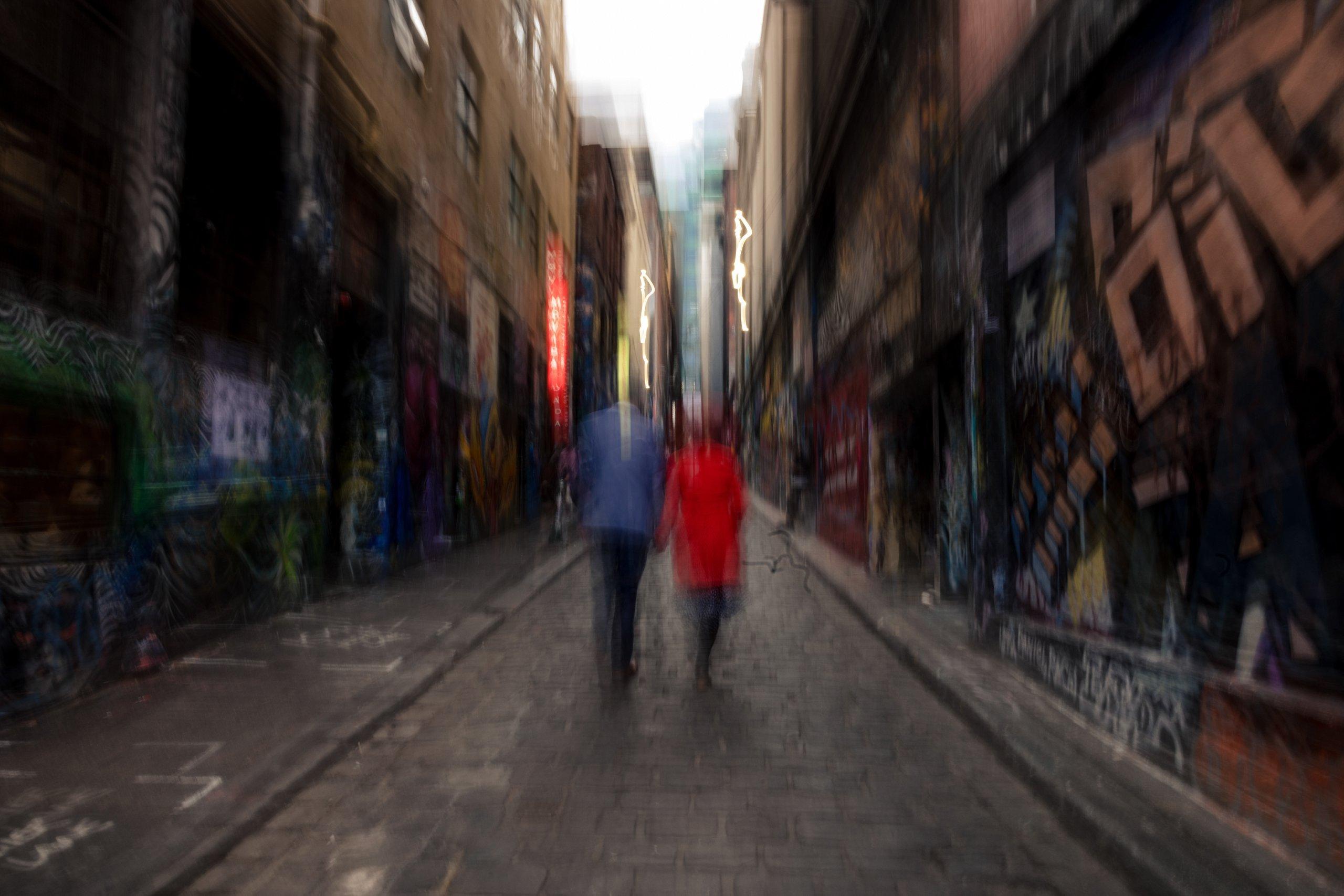 slow shutter photo of couple walking through Hosier Lane