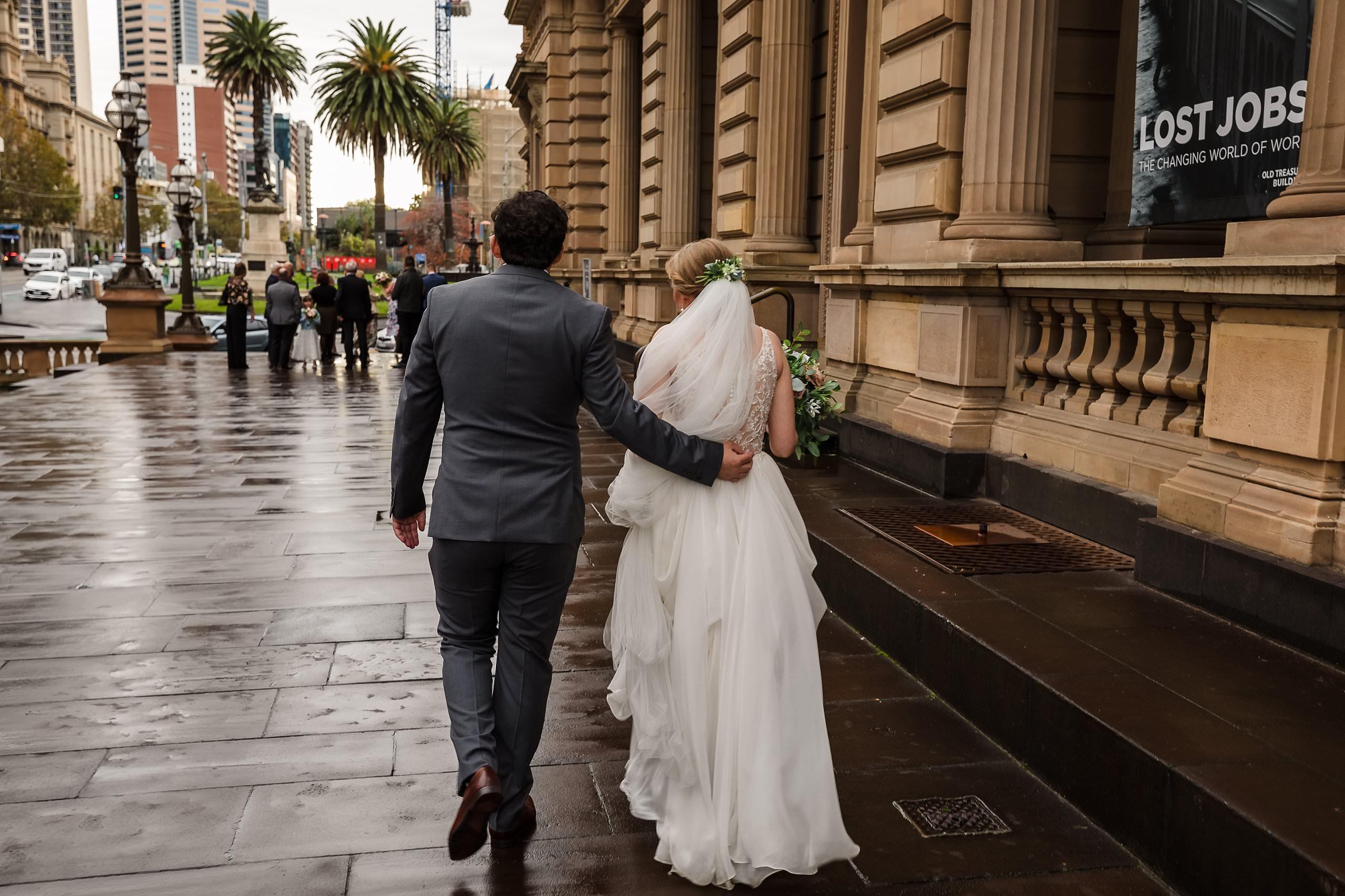 bride and groom walking along the old treasury building in Melbourne
