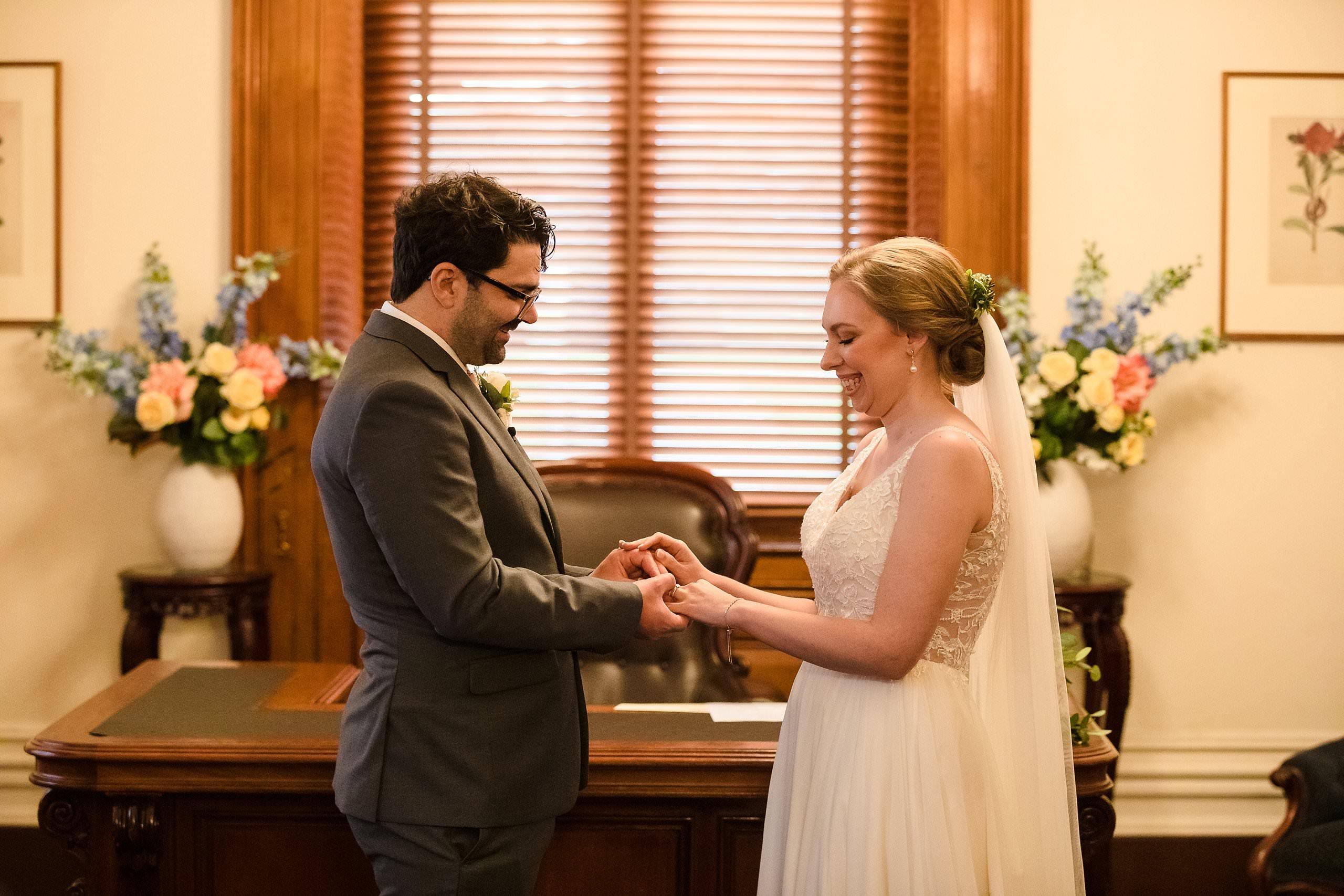 bride and groom exchange rings during romantic elopement ceremony