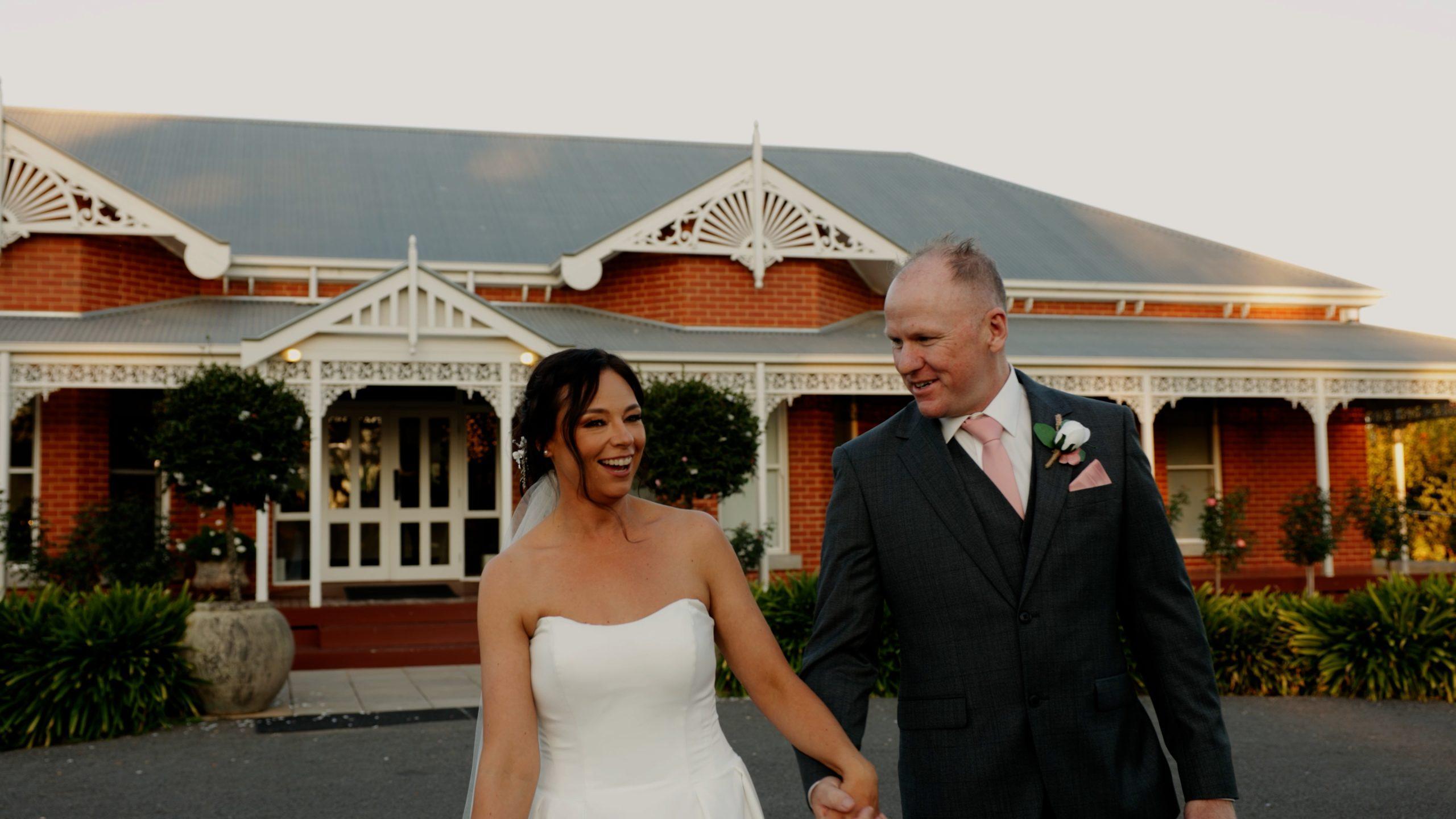 Bride and Groom smiling in front of the Olivehouse in Shepparton during their one of their weddings