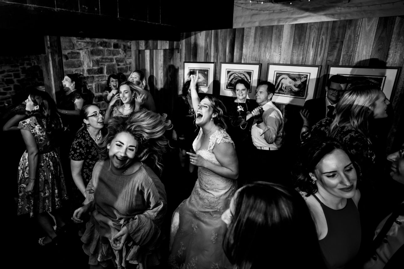 black and white images of bride dancing in the middle of the dancefloor